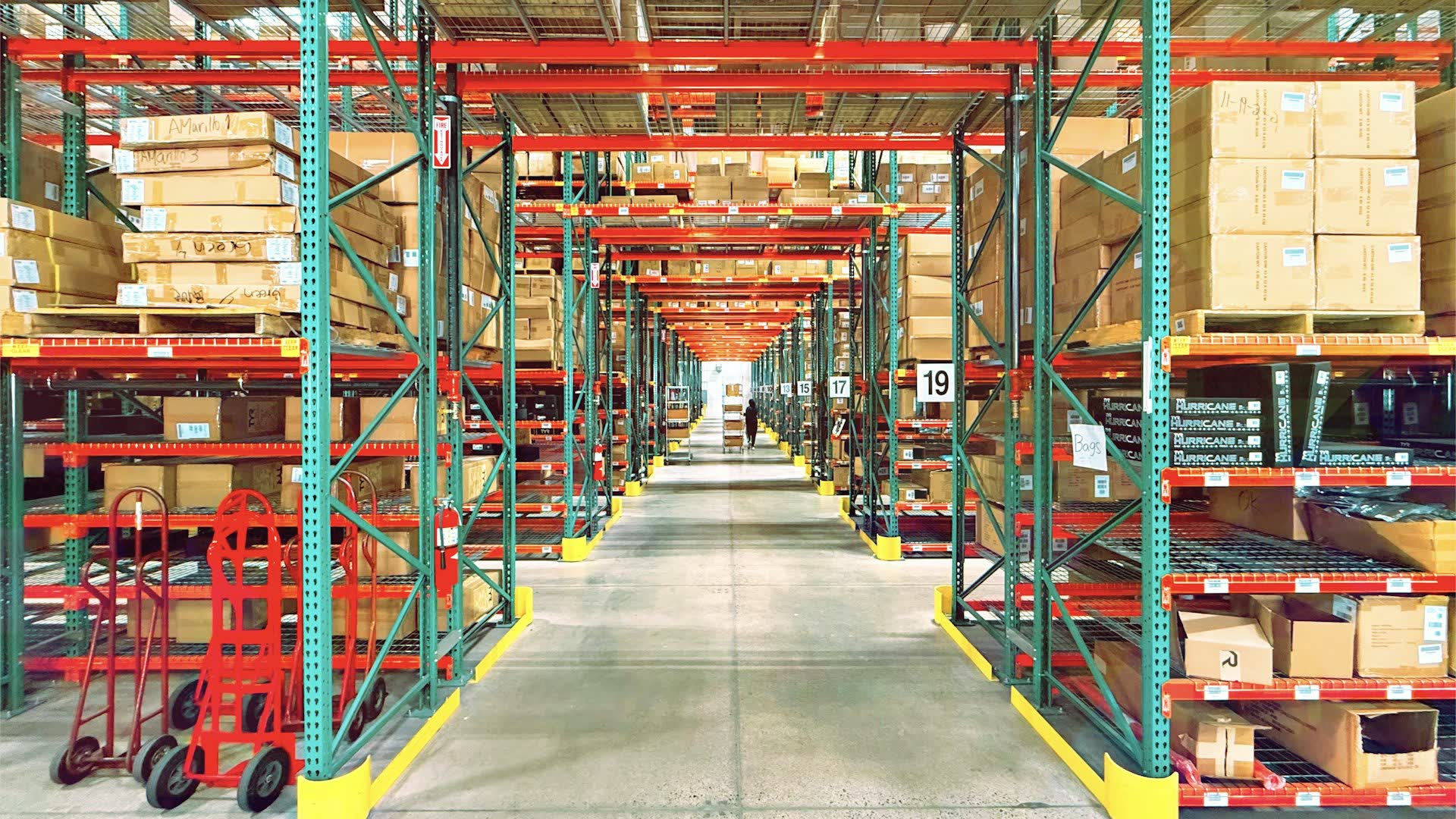 Logistics warehouse with organised pallet racks and stock