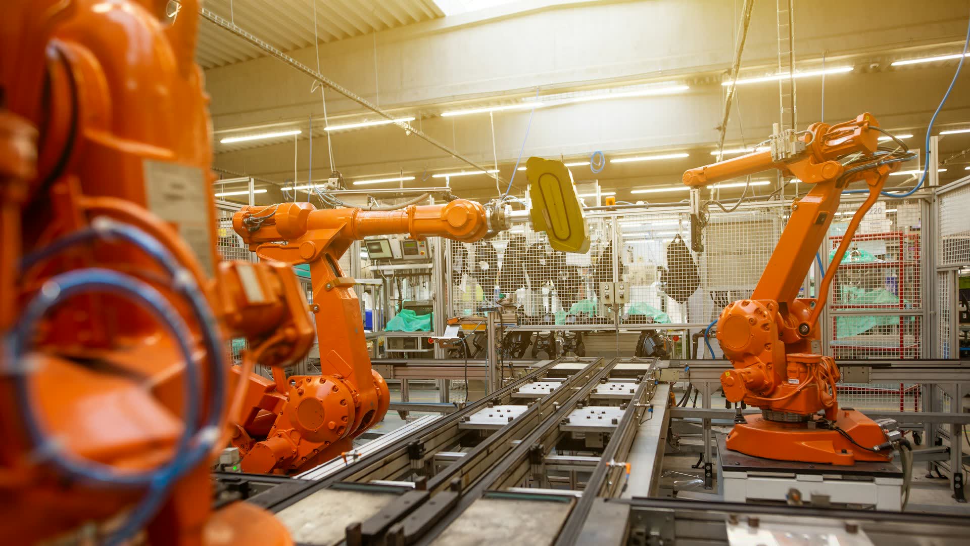 Manufacturing floor with robotic arms on an automated production line